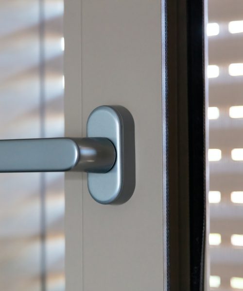 Aluminum door window close up, open glass frame with handle, blur blinds background